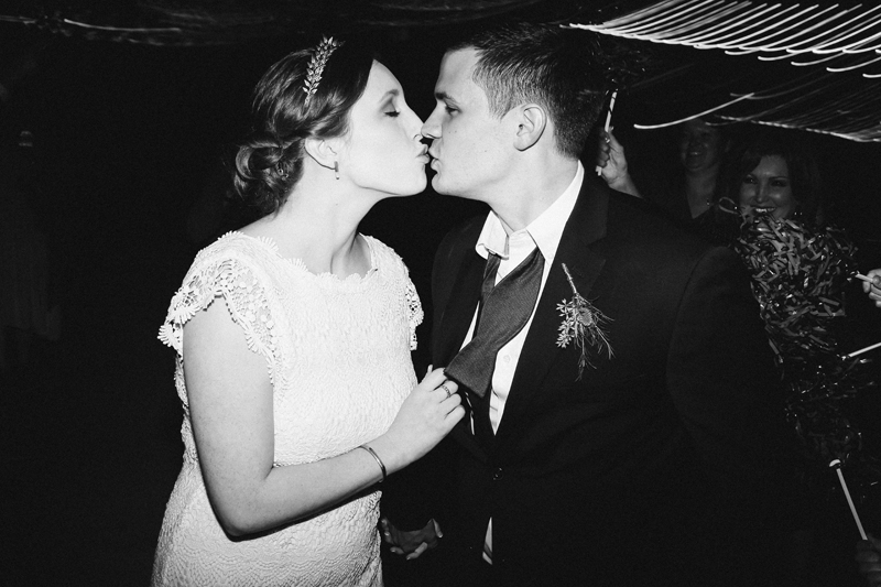 bride and groom exit kiss, eclectic lumberyard wedding