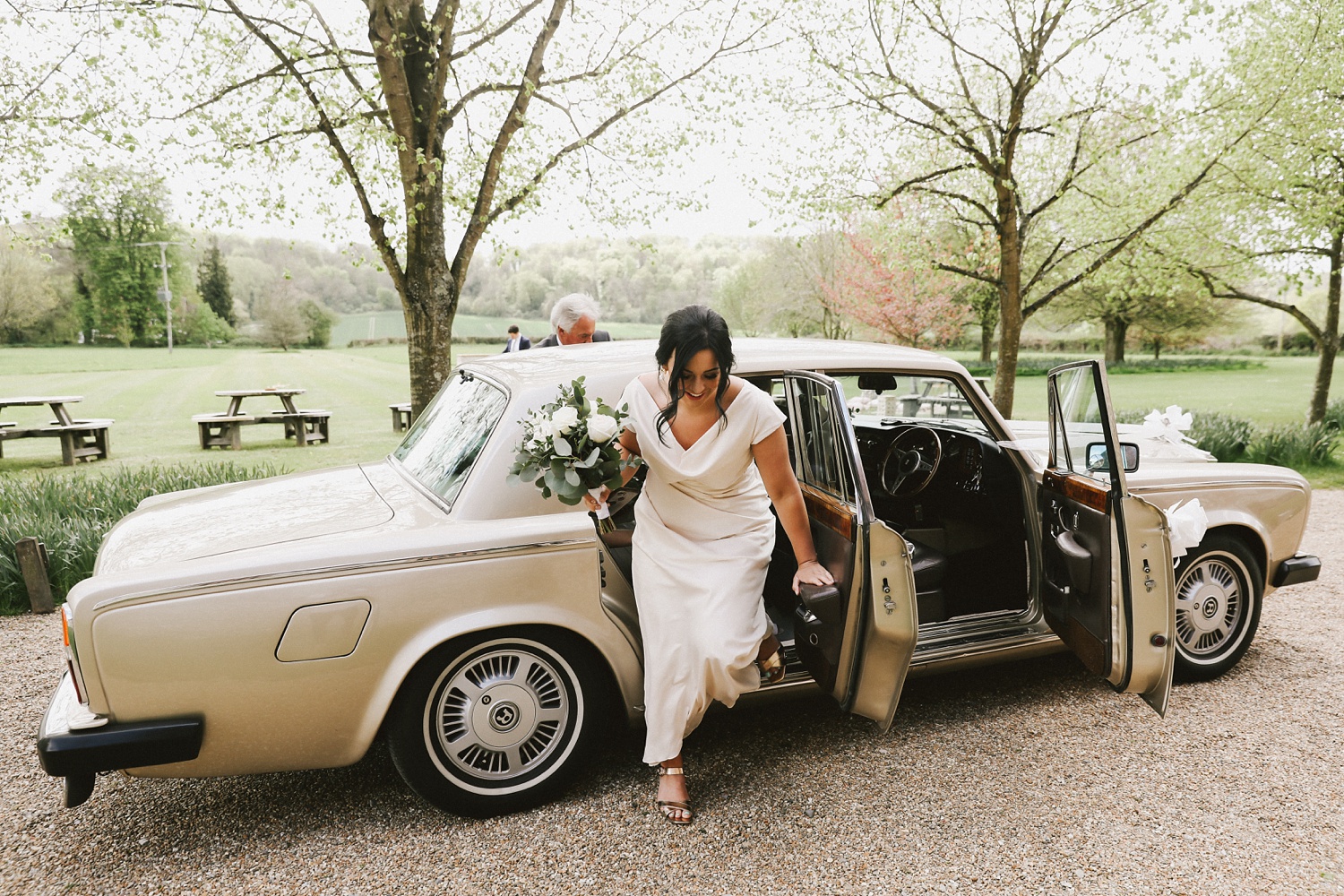 bridesmaid arrive at tithe barn wedding england